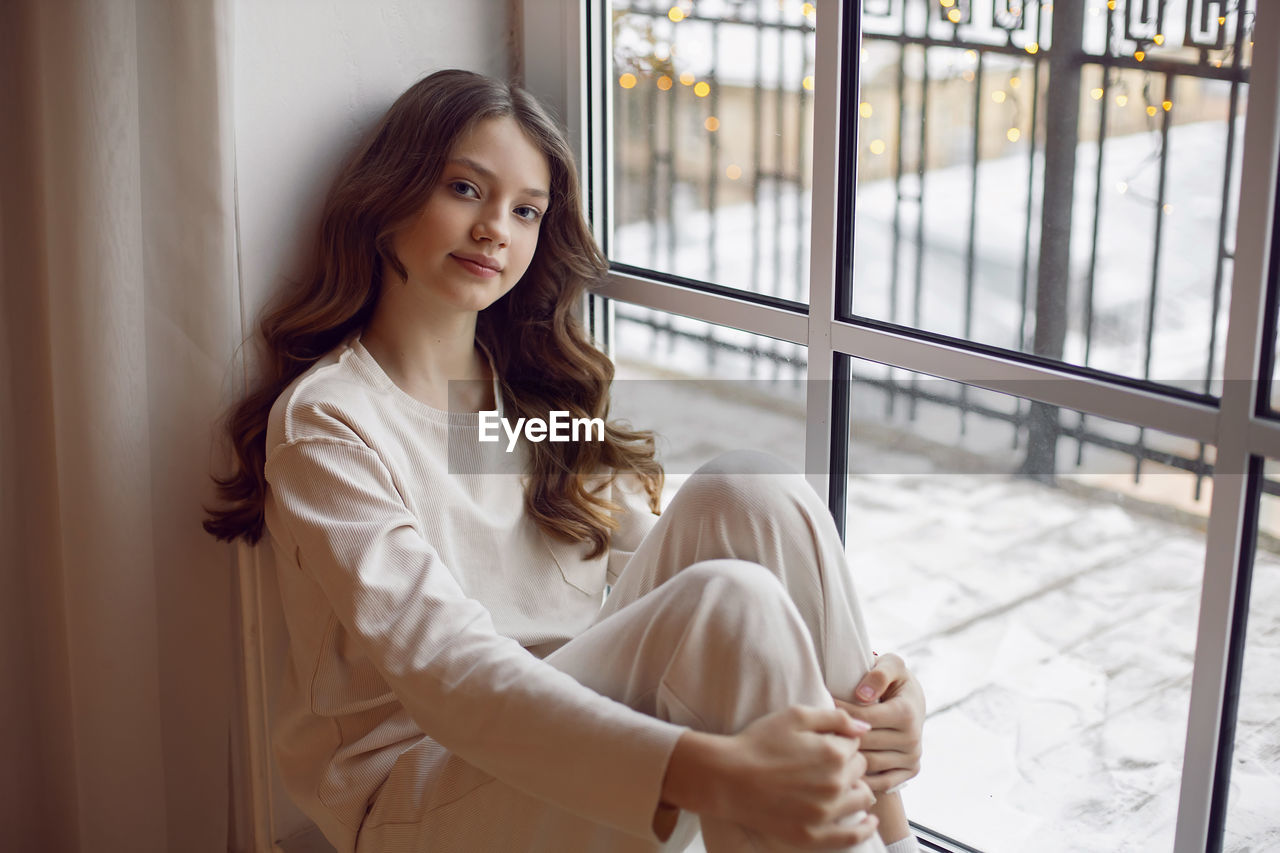 women, adult, one person, indoors, young adult, long hair, clothing, smiling, looking, window, photo shoot, hairstyle, architecture, business, brown hair, happiness, portrait, sitting, dress, lifestyles, female, person, casual clothing, emotion, spring, portrait photography, contemplation, relaxation, human face, white, day, waist up, three quarter length, business finance and industry