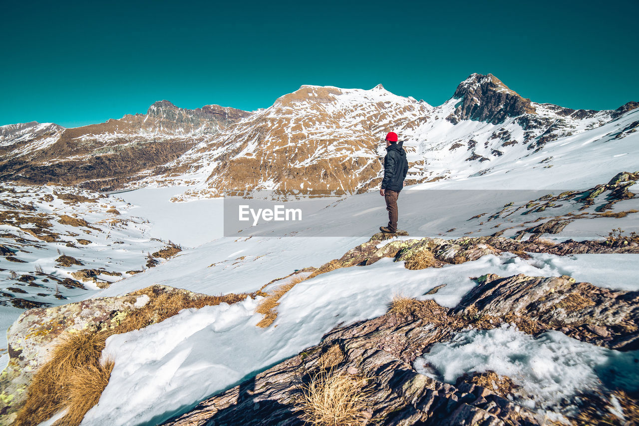 Solo man hiking on italian alps hiker walking during winter concepts about travel  lifestyle 