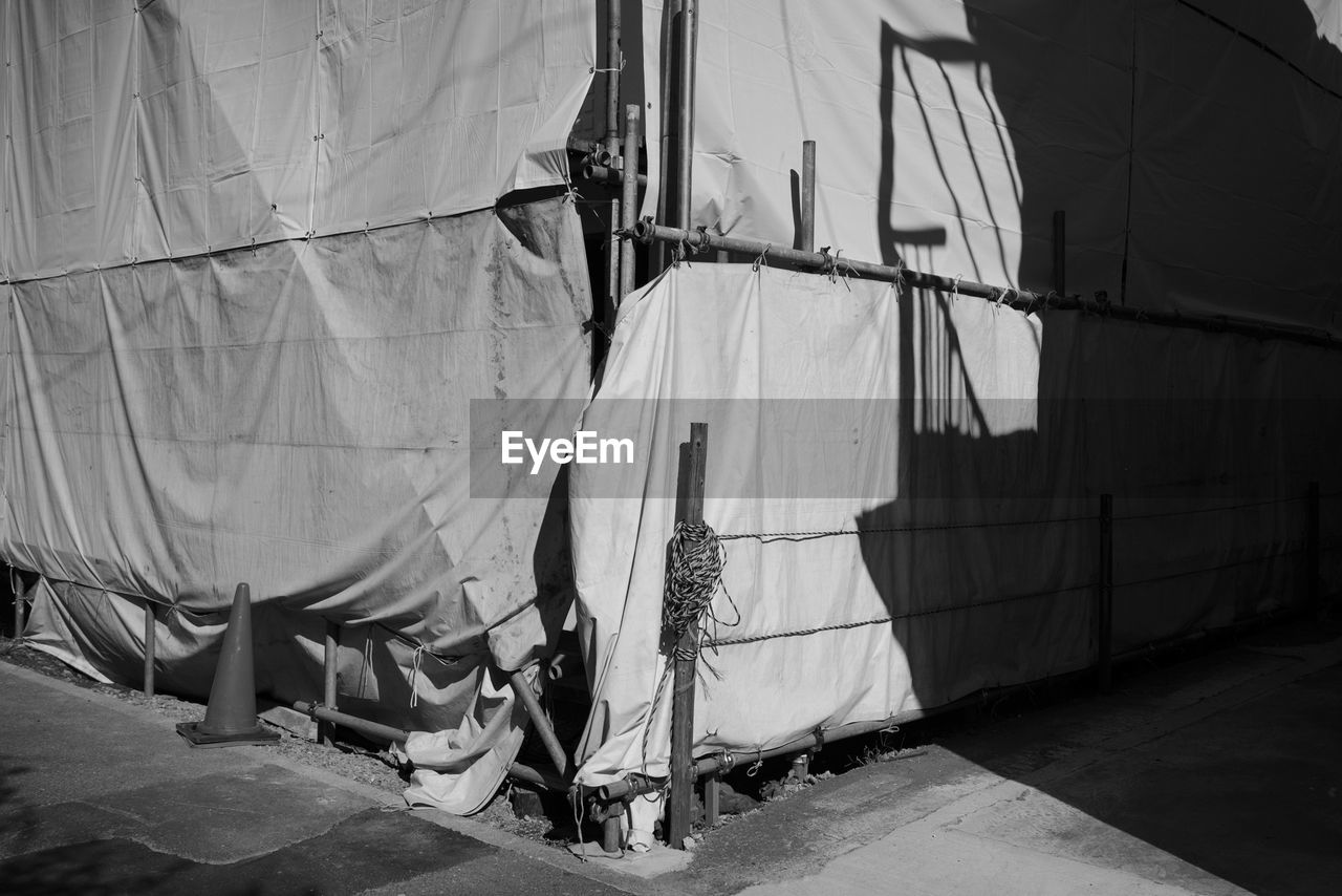 LOW SECTION OF MAN WITH UMBRELLA ON FLOOR