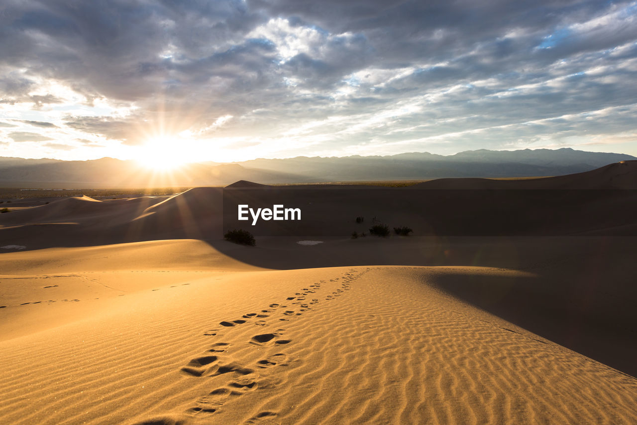 Scenic view of desert against sky during sunset