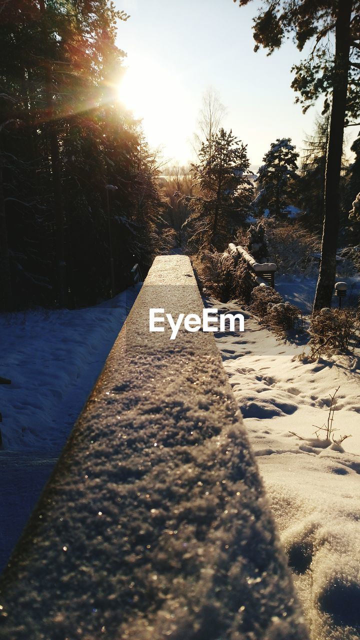 SURFACE LEVEL OF SNOW COVERED ROAD AGAINST SKY