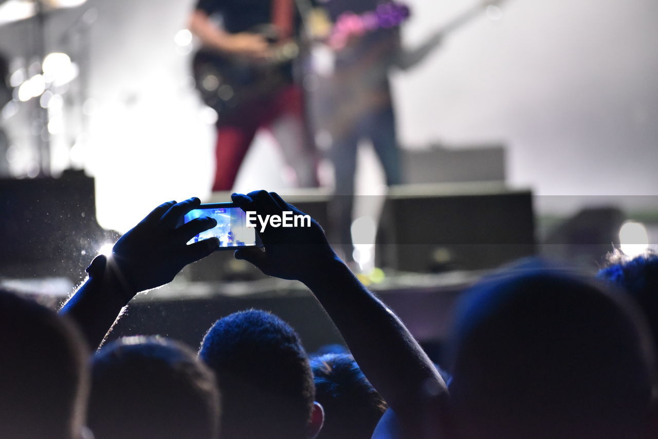 Man photographing at music concert