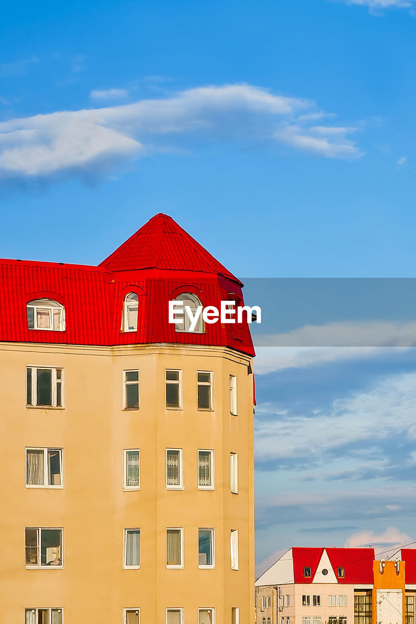architecture, building exterior, built structure, building, sky, residential district, house, cloud, city, red, nature, window, no people, home ownership, outdoors, blue, apartment, day, roof, travel destinations, town, tower, home