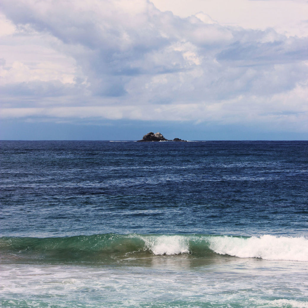 Scenic view of sea against cloudy sky