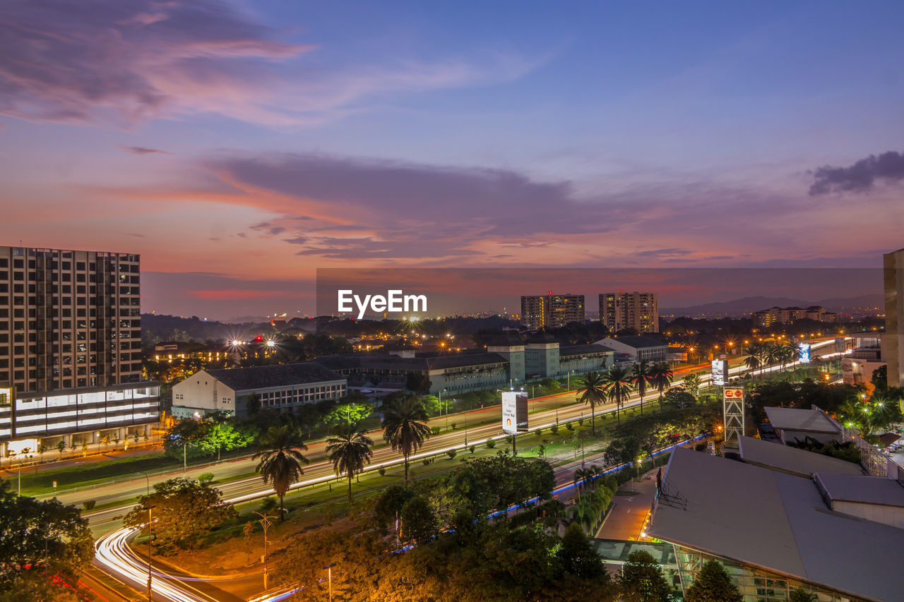 High angle view of illuminated cityscape against sky during sunset