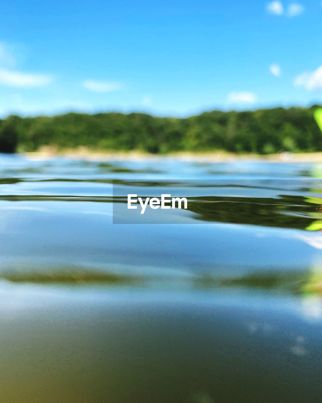 SURFACE LEVEL OF LAKE AGAINST BLUE SKY