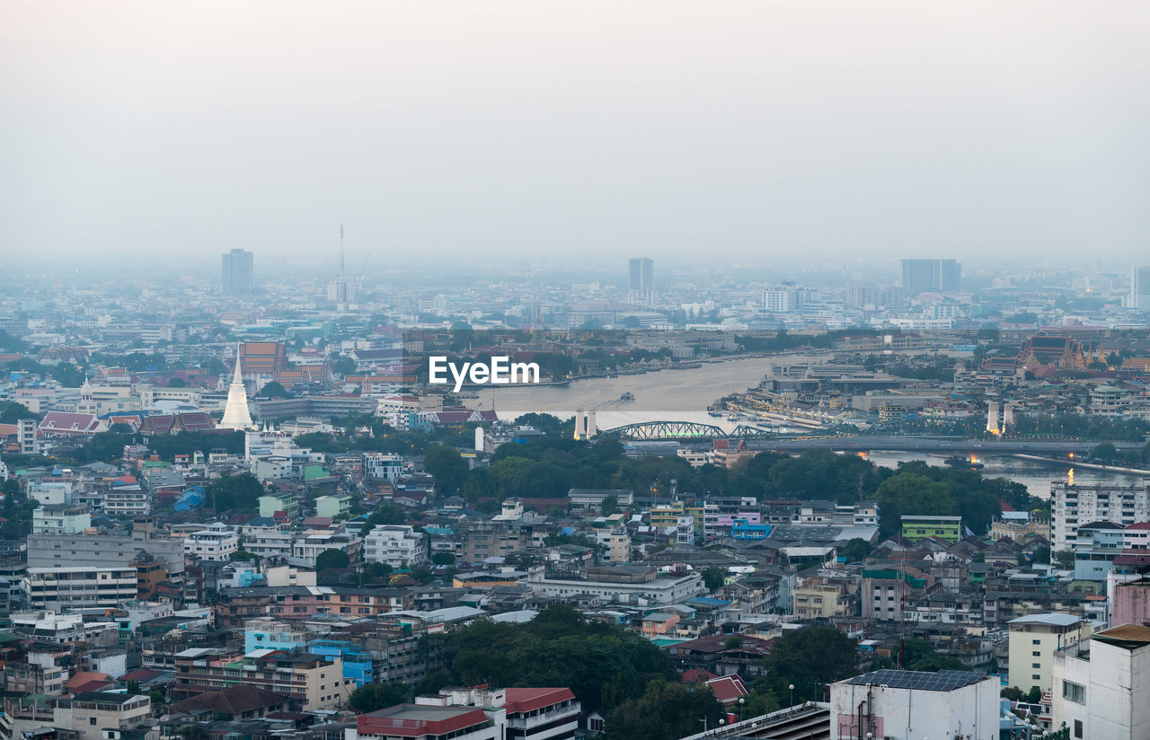 Aerial view landscape bangkok city and building along chaophraya river on evening, thailand