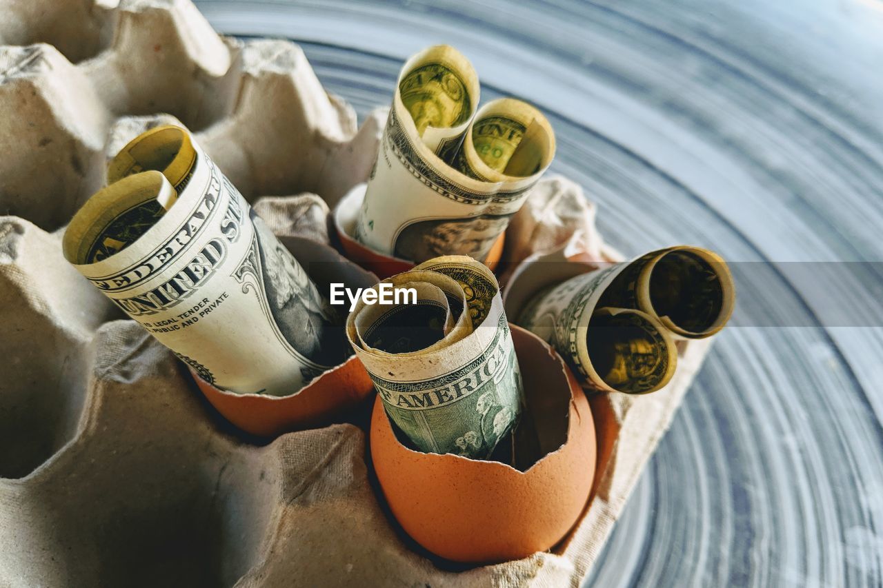 Close-up of banknotes in eggshells