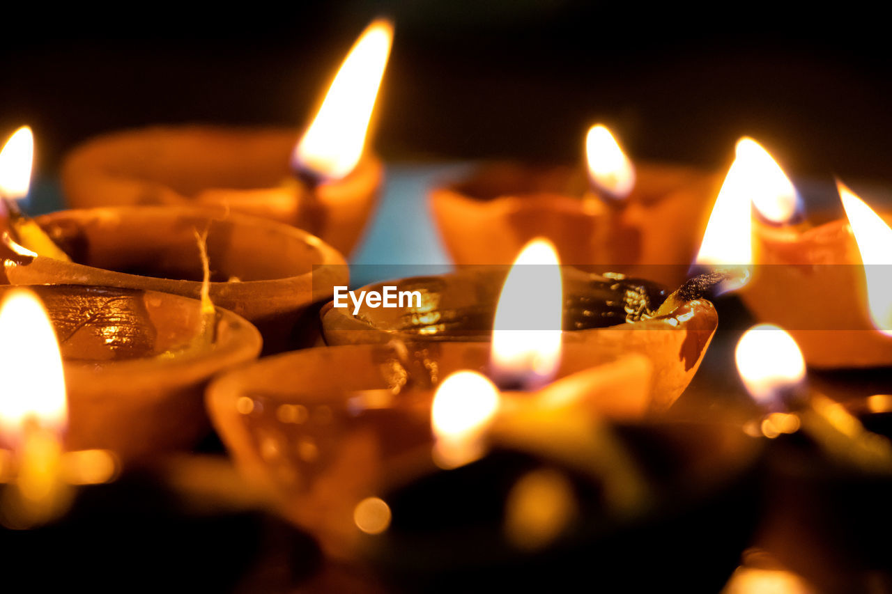 Close-up of diyas burning