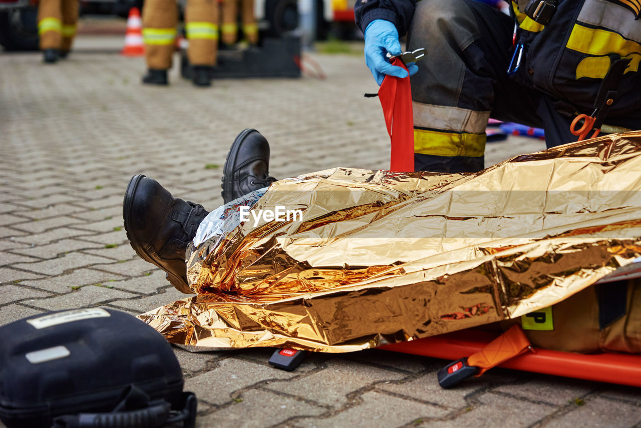 Rescuers provide first aid to the victim during car road accident