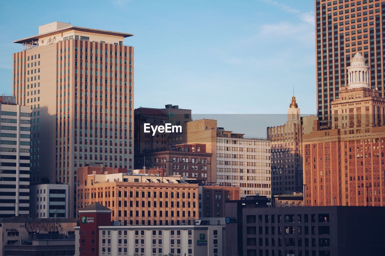 Modern buildings in city against sky