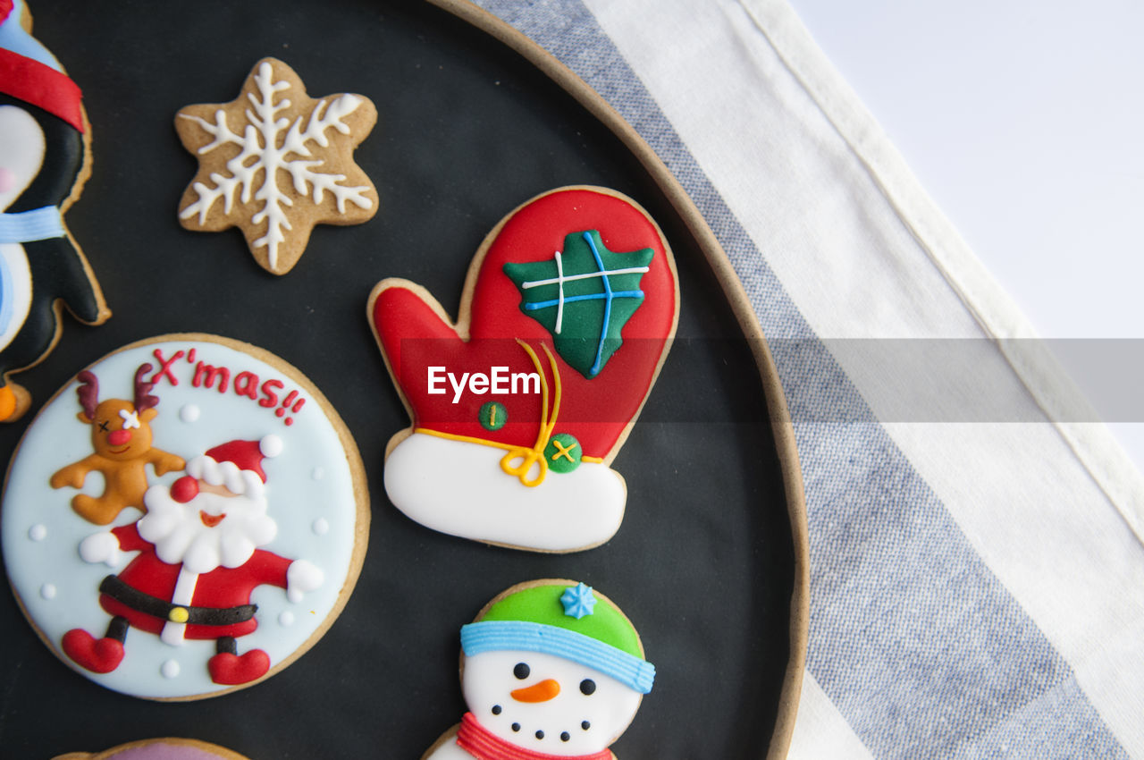 Multi colored gingerbread cookies during christmas in plate