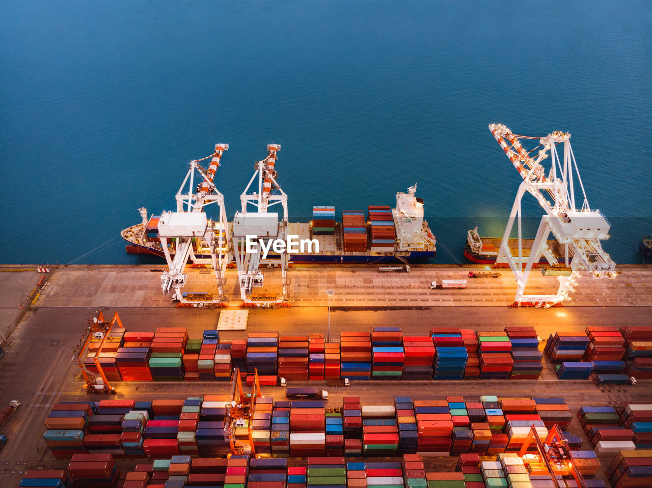 HIGH ANGLE VIEW OF COMMERCIAL DOCK BY SEA