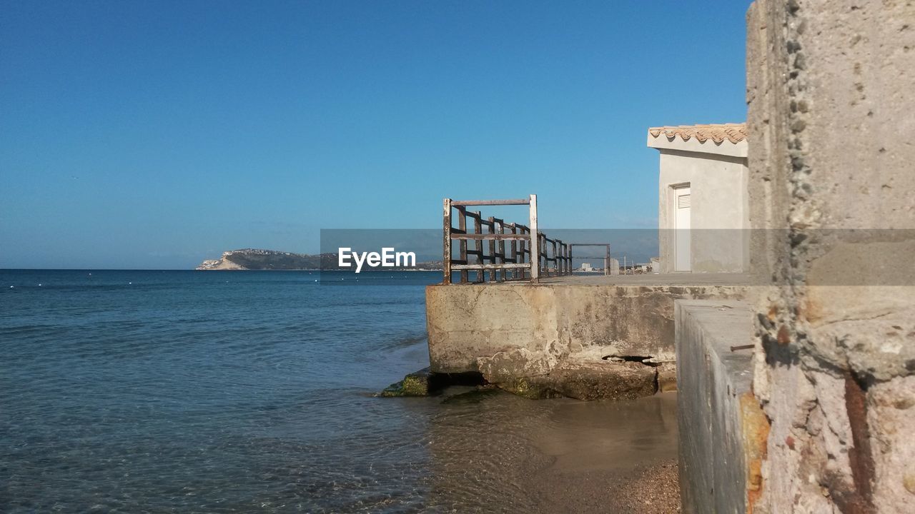 Scenic view of sea against clear blue sky