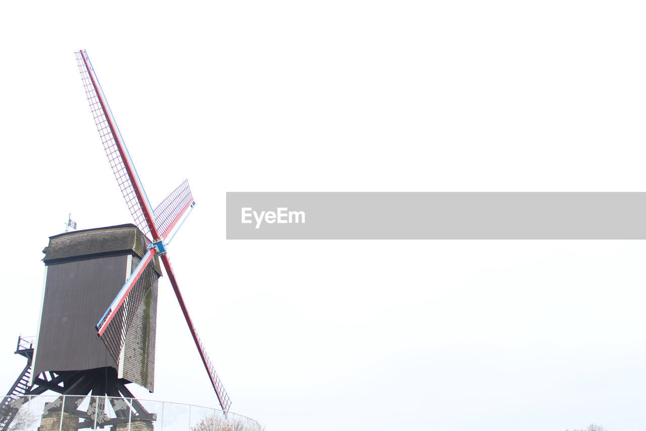 LOW ANGLE VIEW OF TRADITIONAL WINDMILLS AGAINST CLEAR SKY