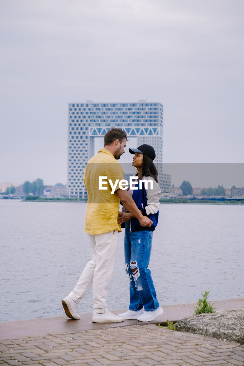 Couple standing by sea