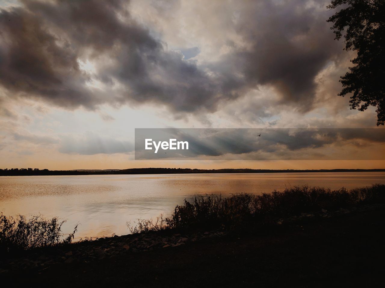 Scenic view of lake against sky during sunset