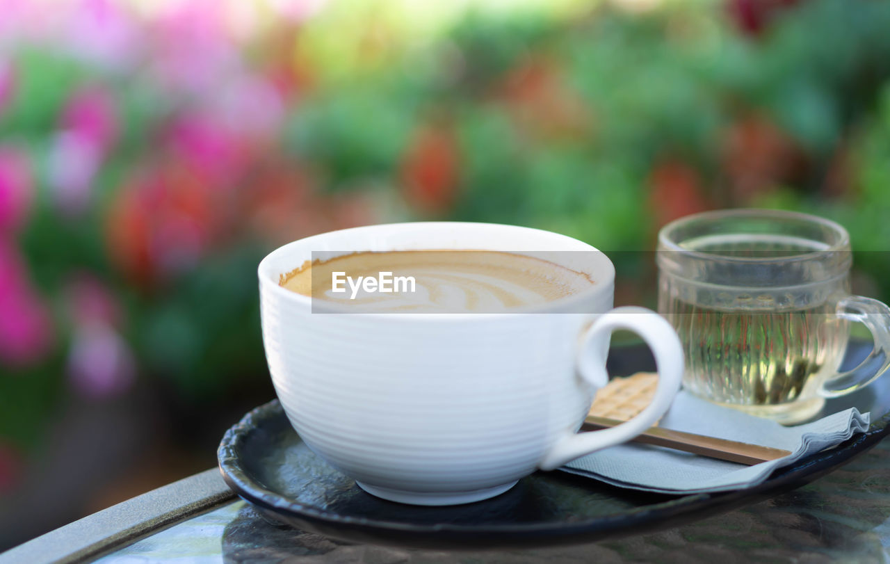CLOSE-UP OF COFFEE SERVED ON TABLE AT CAFE