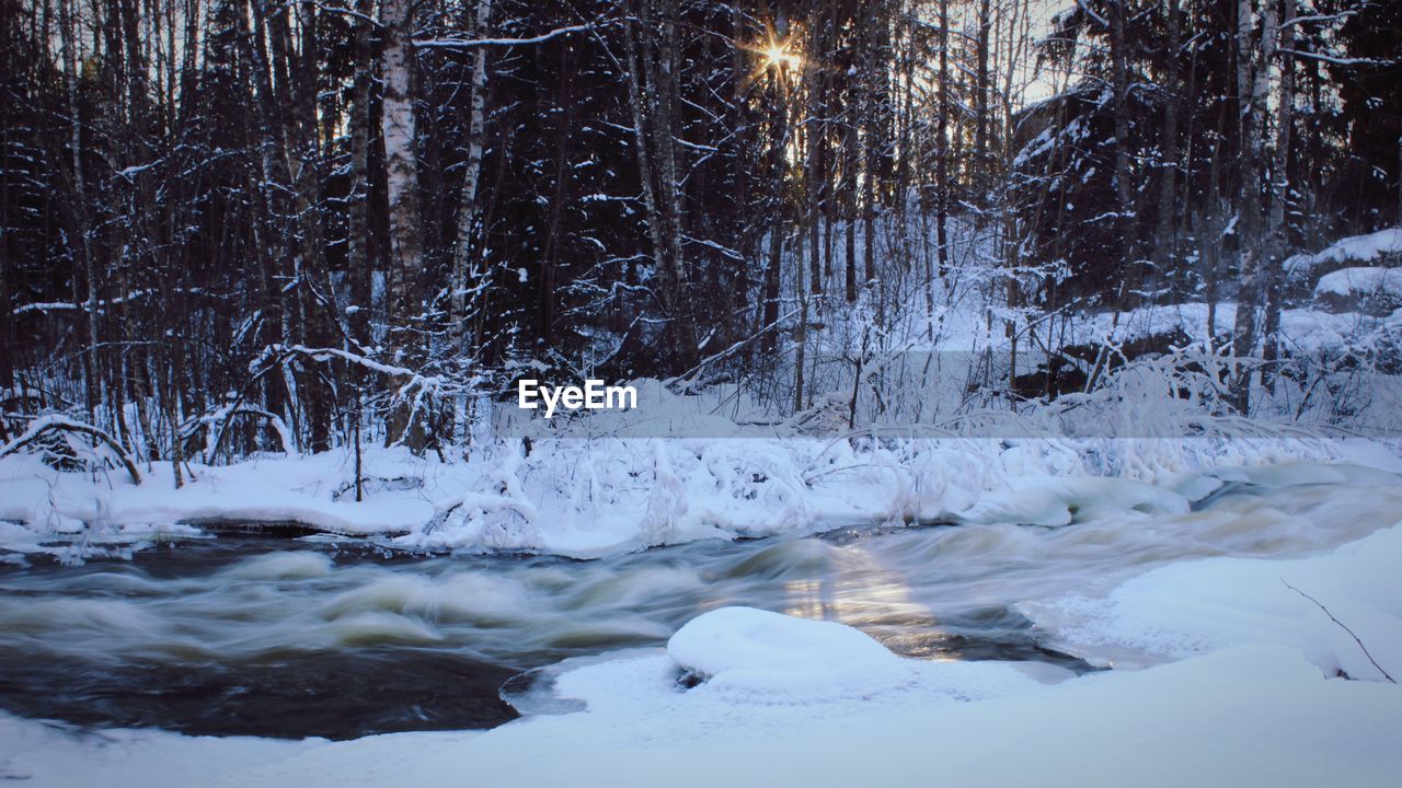 FROZEN LAKE AGAINST SKY DURING WINTER