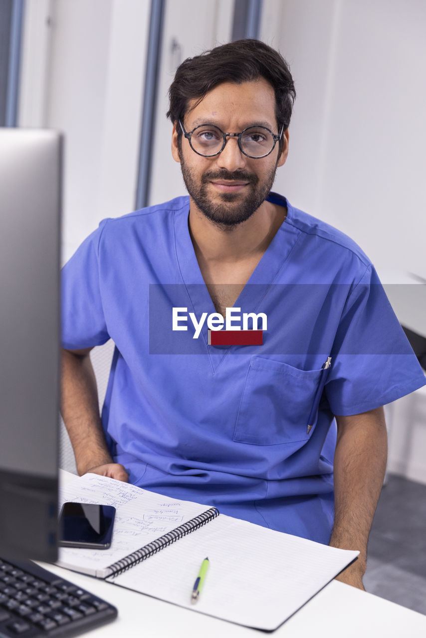 Doctor in office looking at camera