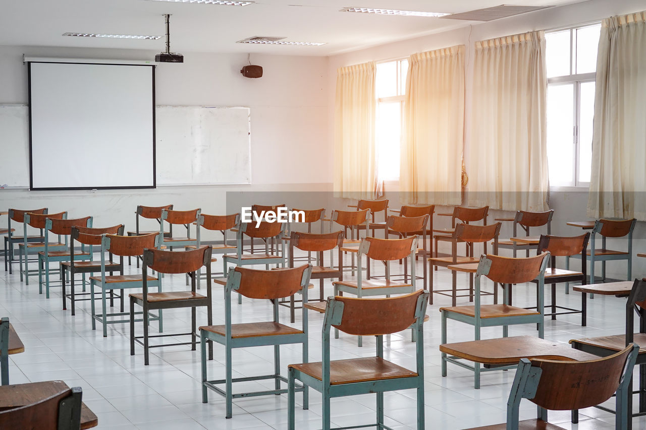 Empty chairs and tables in classroom