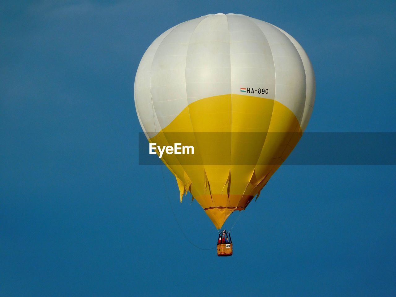 Low angle view of hot air balloon against clear blue sky