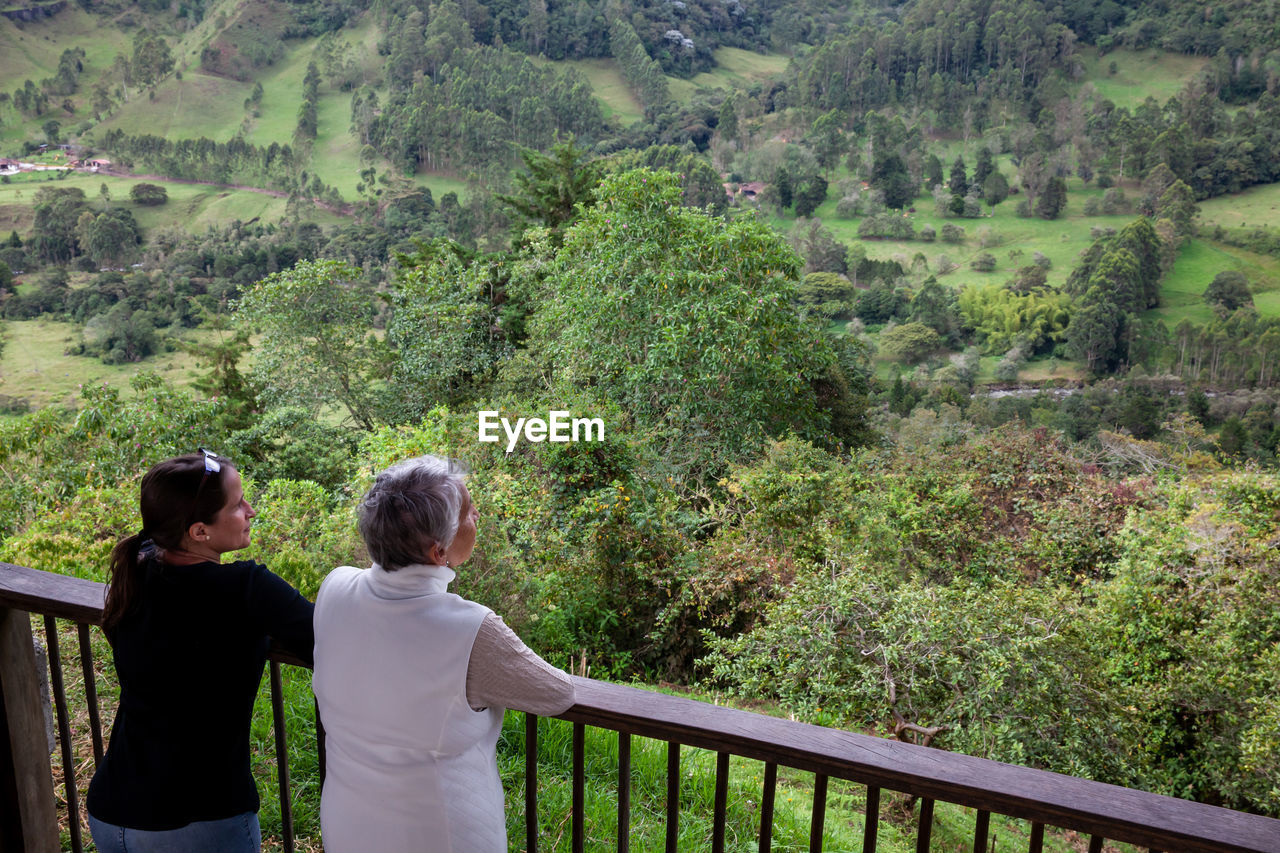 Senior mother and adult daughter traveling at the  view point over the cocora valley at salento