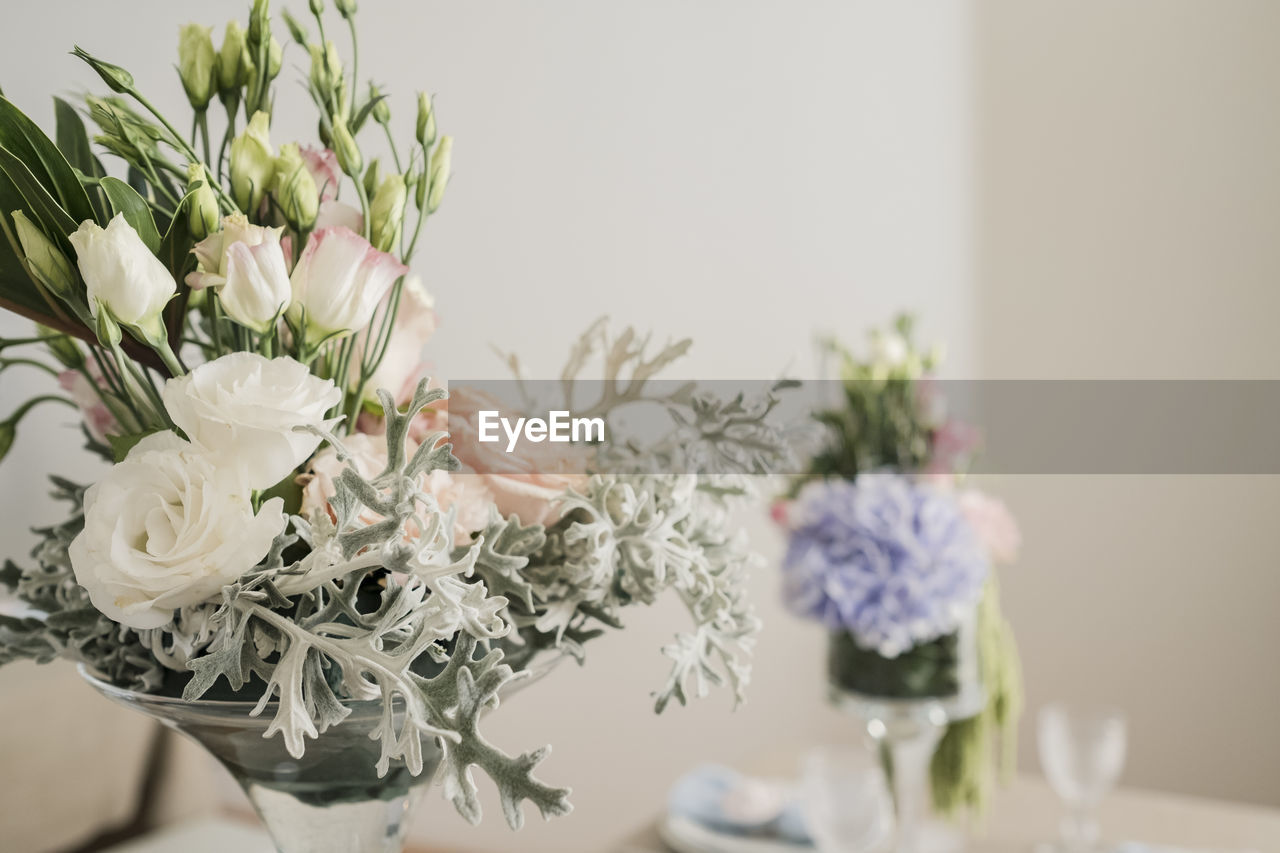 CLOSE-UP OF WHITE ROSES IN VASE