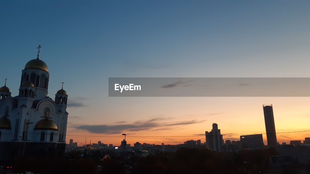 BUILDINGS AGAINST SKY AT SUNSET