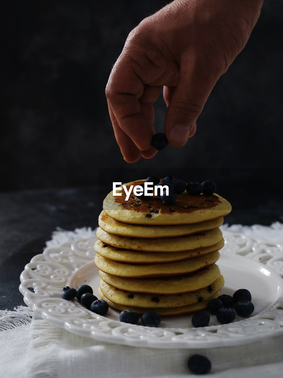 cropped hand of person holding cake