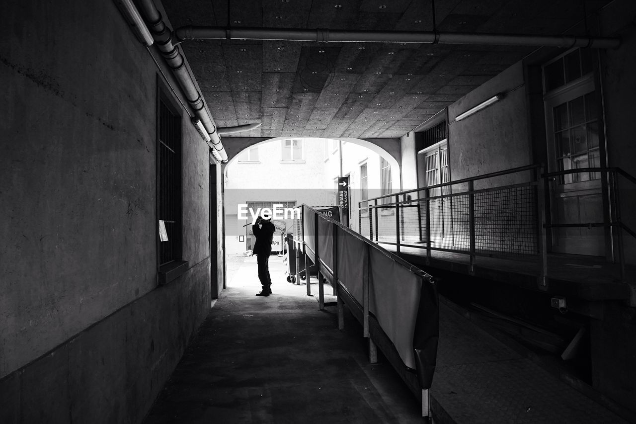 Silhouette of people walking in corridor
