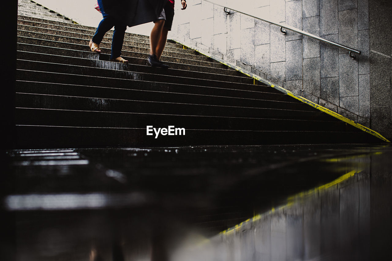 Low section of people walking on steps