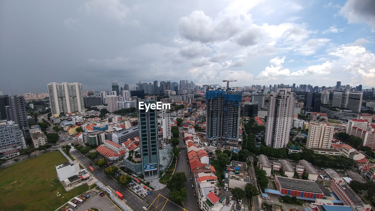 High angle view of modern buildings in city against sky