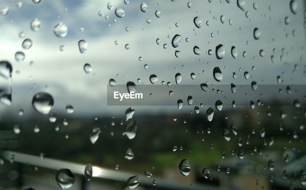 Close-up of rain drops on glass window