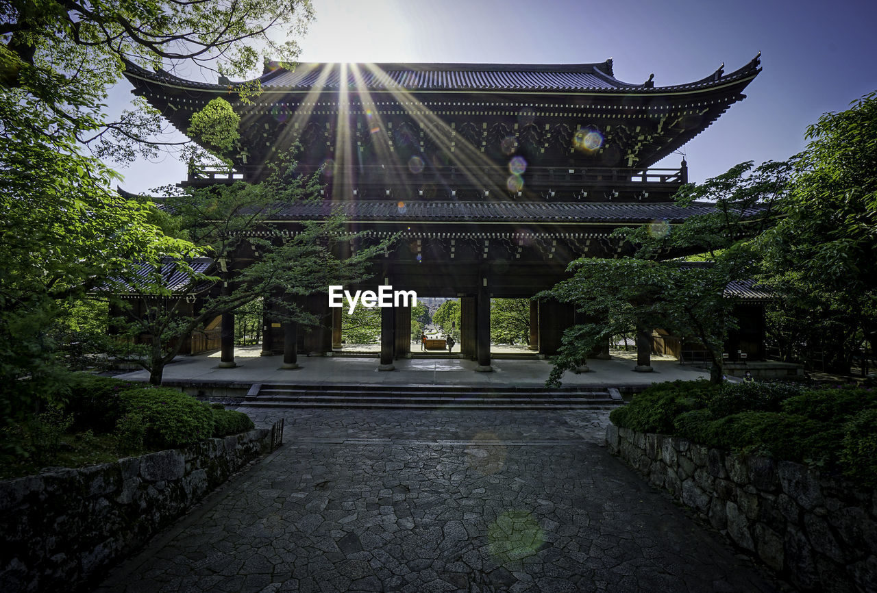 VIEW OF BUILT STRUCTURE WITH TREES IN BACKGROUND