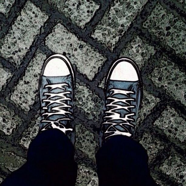 LOW SECTION OF WOMAN STANDING ON TILED FLOOR