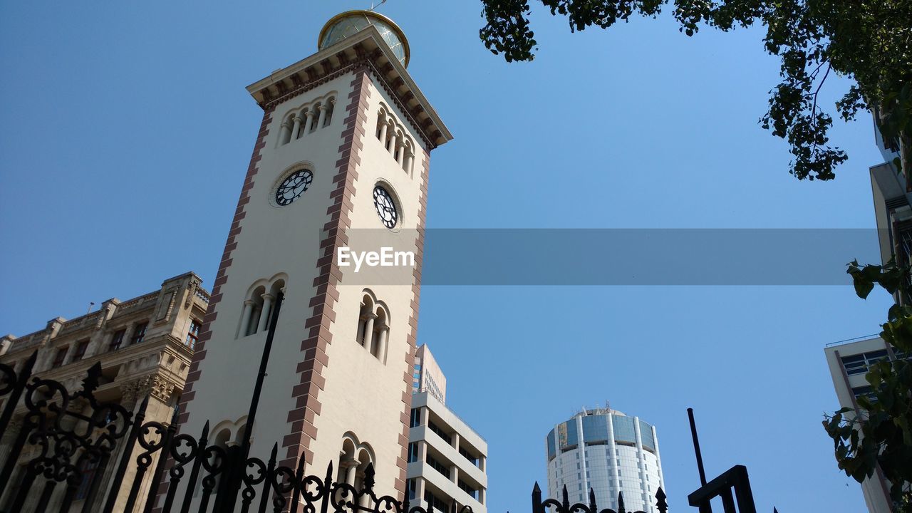 Low angle view of building against clear blue sky