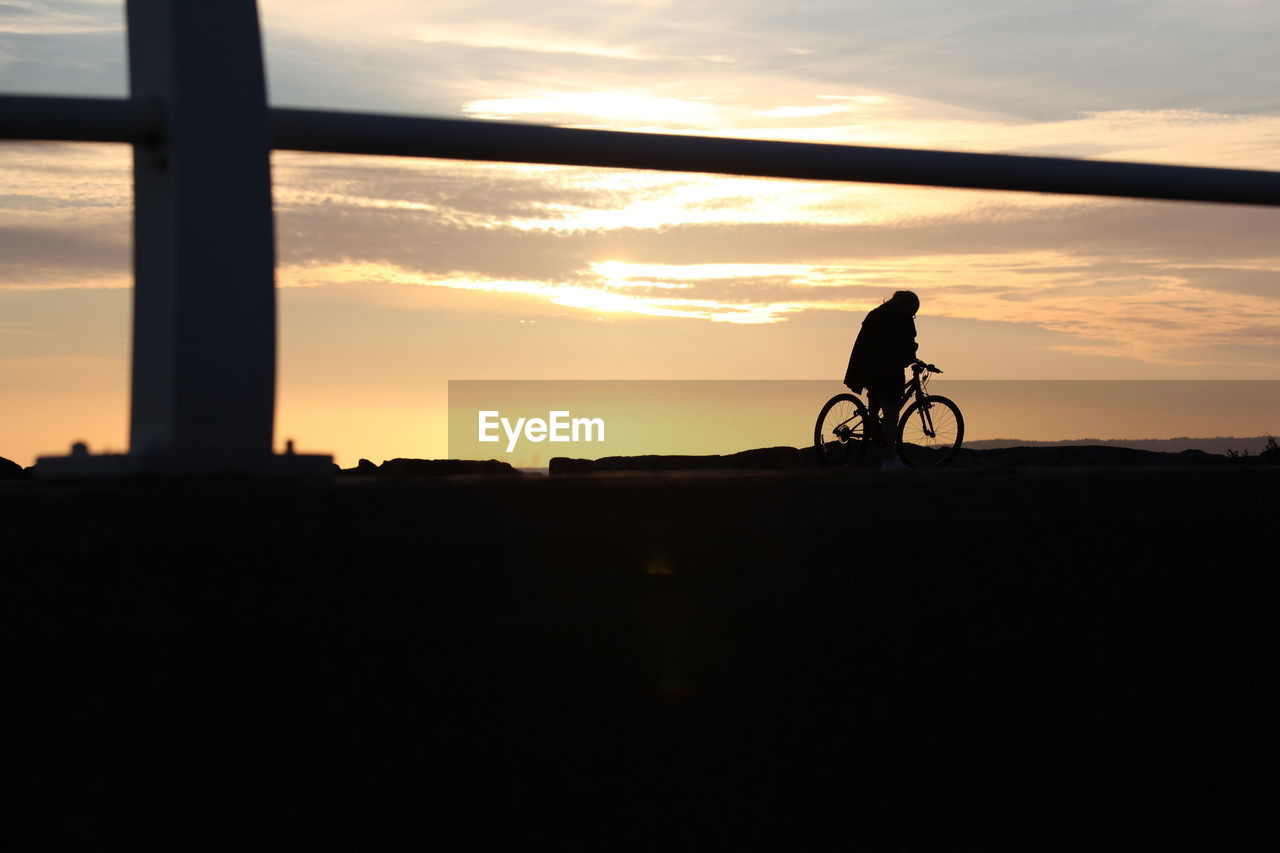 Silhouetted cyclist.