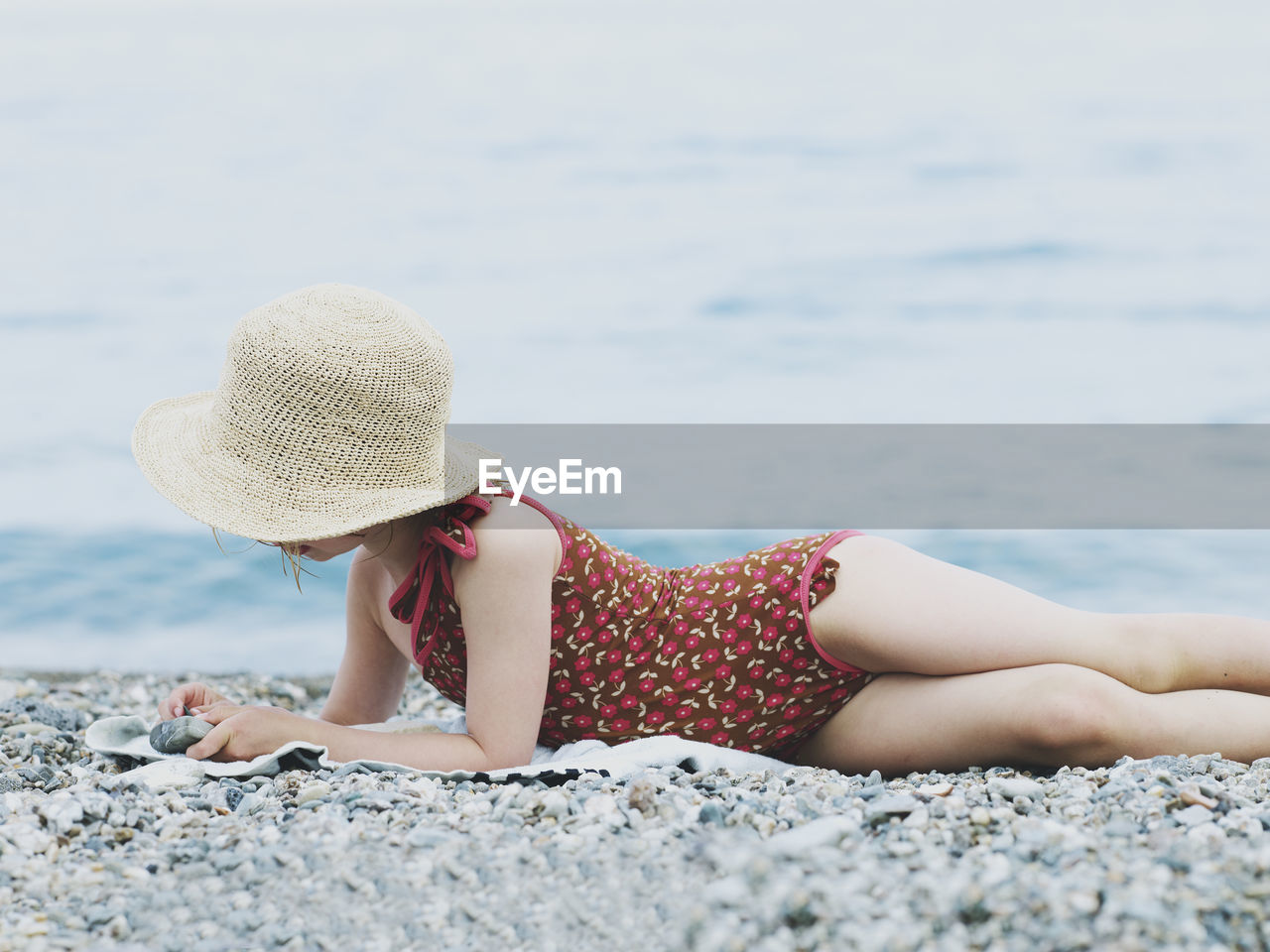 Girl playing with stones on beach