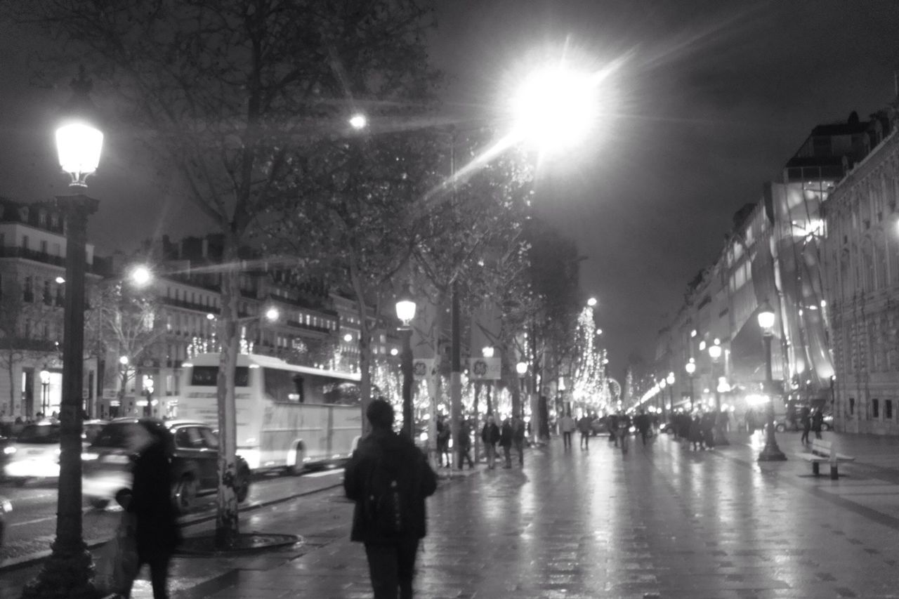 VIEW OF ILLUMINATED CITY STREET AT NIGHT
