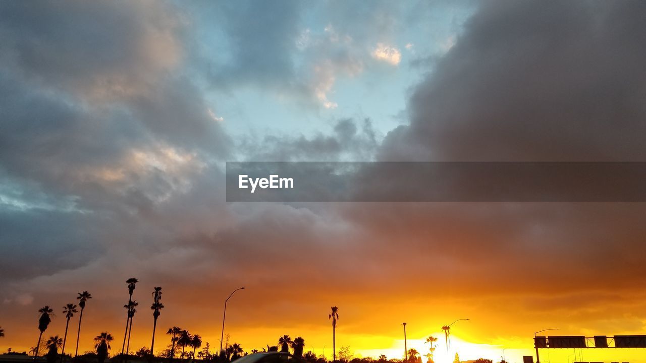 Low angle view of dramatic sky during sunset