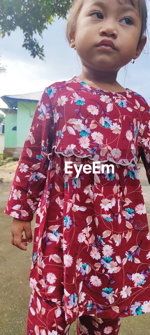 child, childhood, one person, floral pattern, female, standing, dress, women, clothing, spring, portrait, day, pattern, front view, nature, looking, pink, innocence, person, cute, lifestyles, emotion, kimono, leisure activity, outdoors, three quarter length, casual clothing, smiling, toddler, happiness, costume, sky, human face, looking away, looking up, waist up