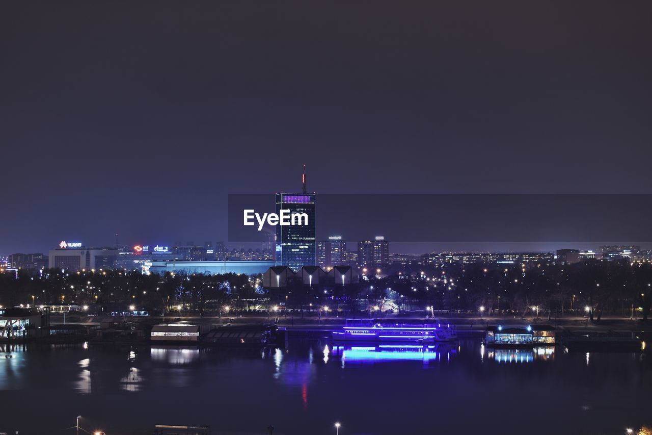 ILLUMINATED BUILDINGS AT WATERFRONT