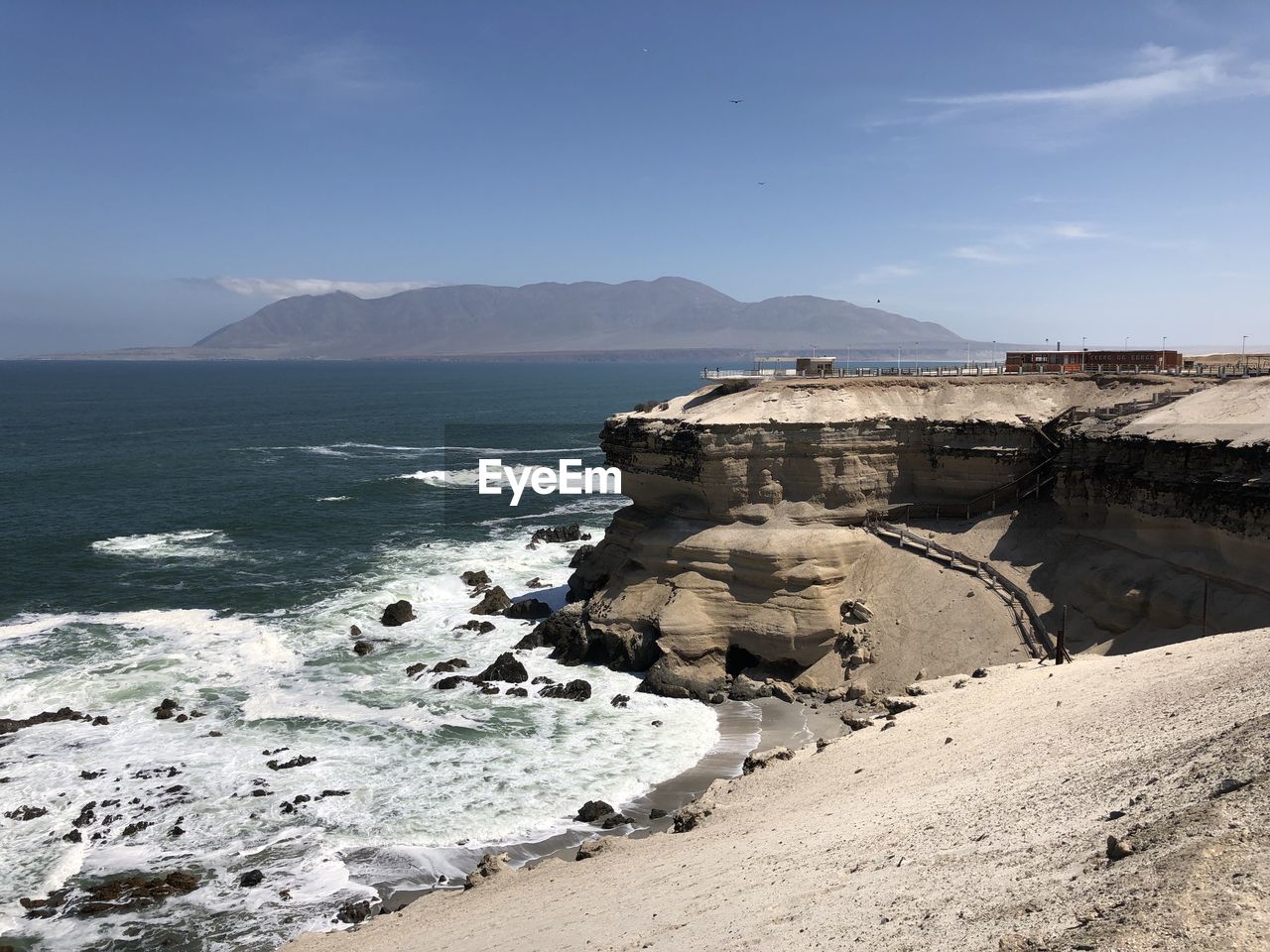 sea, water, land, beach, coast, sky, ocean, rock, shore, scenics - nature, nature, body of water, cliff, beauty in nature, wave, terrain, travel destinations, environment, coastline, travel, mountain, landscape, vacation, no people, architecture, sand, tourism, outdoors, motion, bay, tranquility, day, cove, cloud, tranquil scene, holiday, blue, sports, trip, sunny