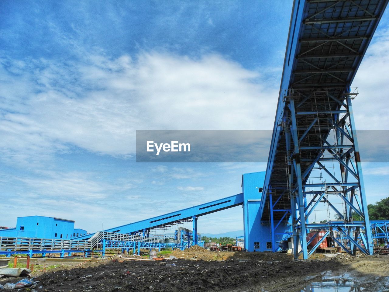 LOW ANGLE VIEW OF BRIDGE AGAINST CLOUDY SKY