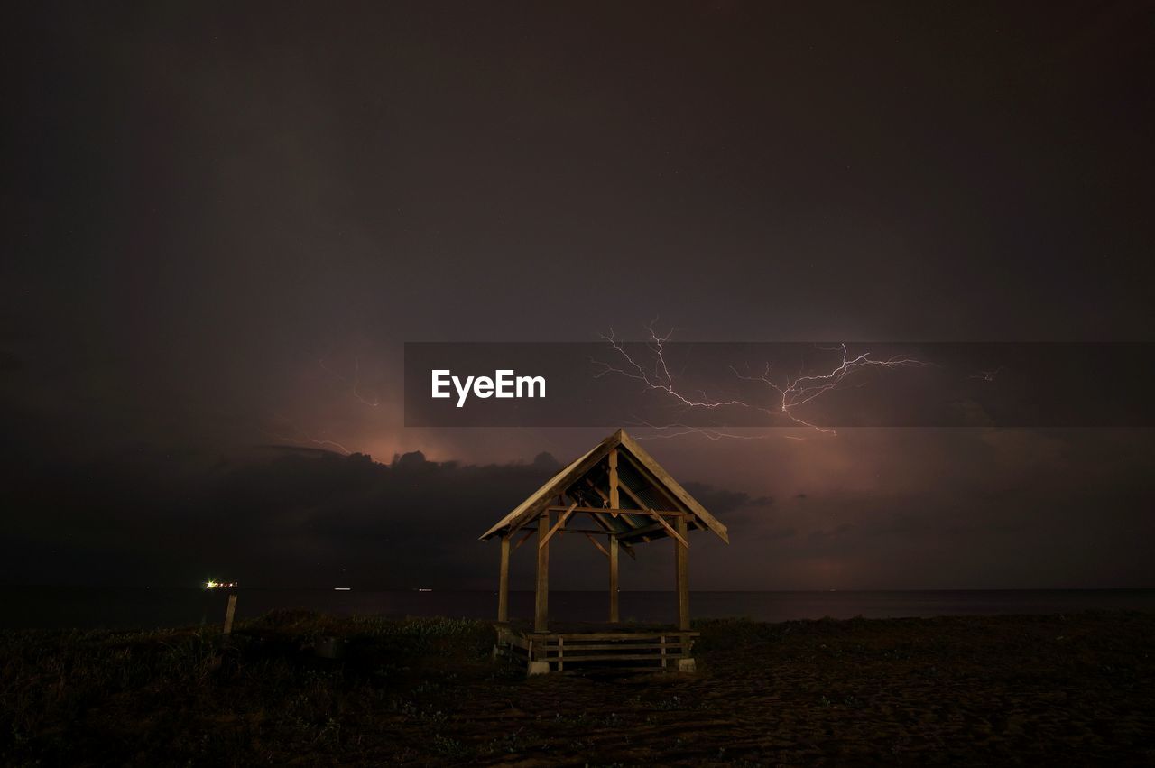 Lightning over sea against sky at night