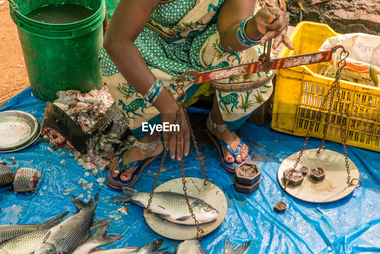 WOMAN WORKING IN BASKET AT MARKET