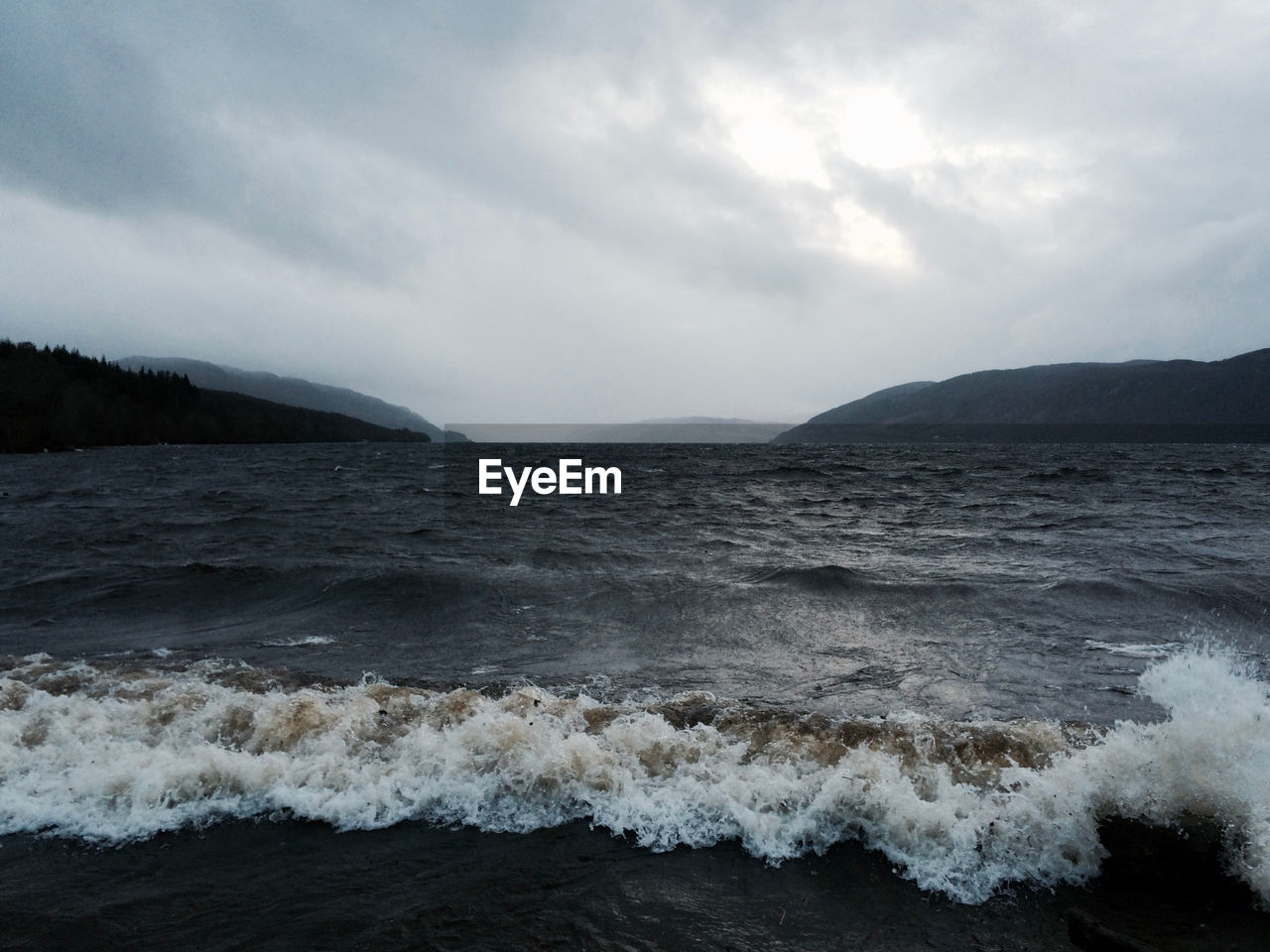 Scenic view of ocean against cloudy sky