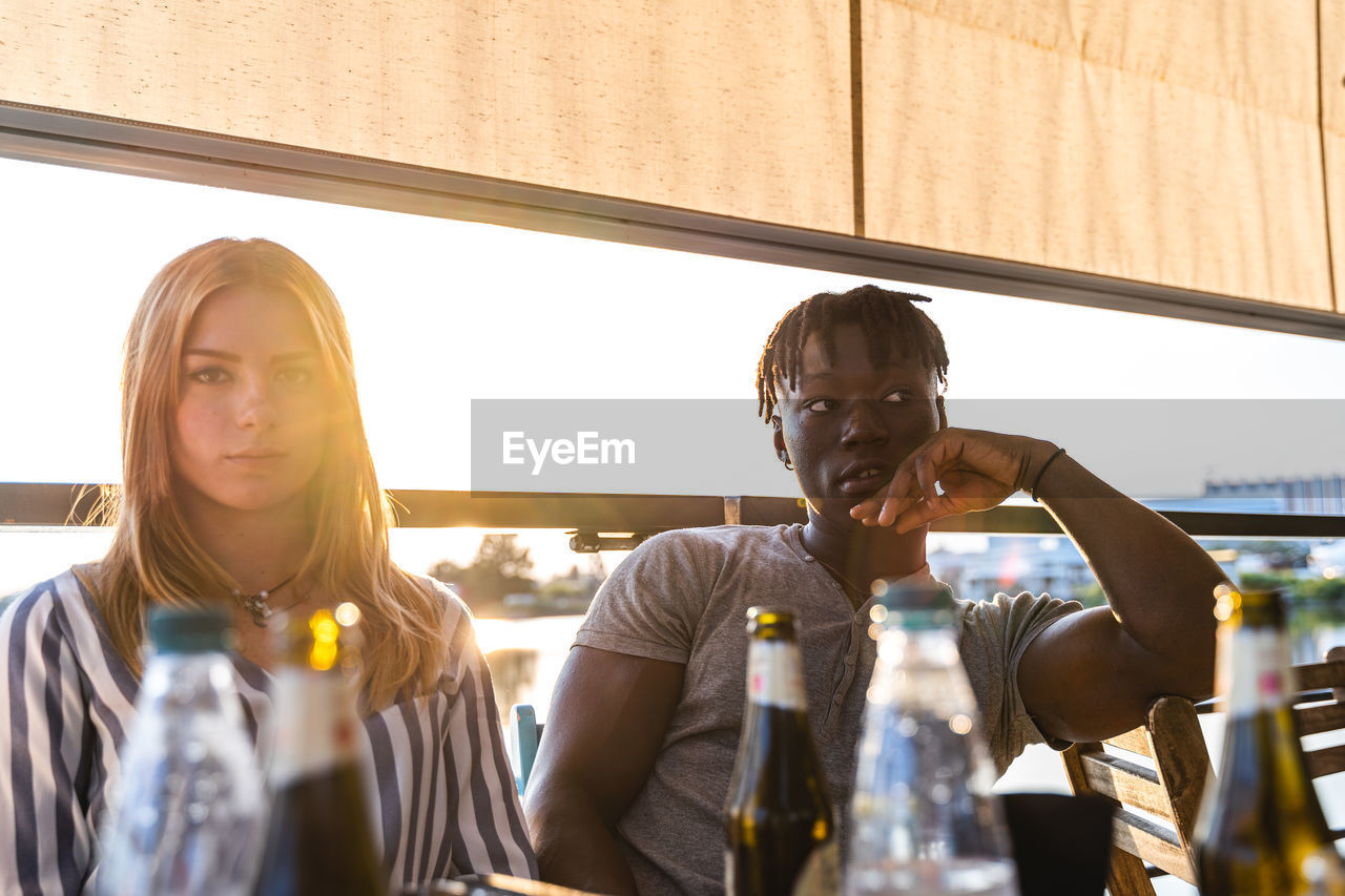 Portrait of an engaged multiethnic couple on summer vacation on a river cruise ship