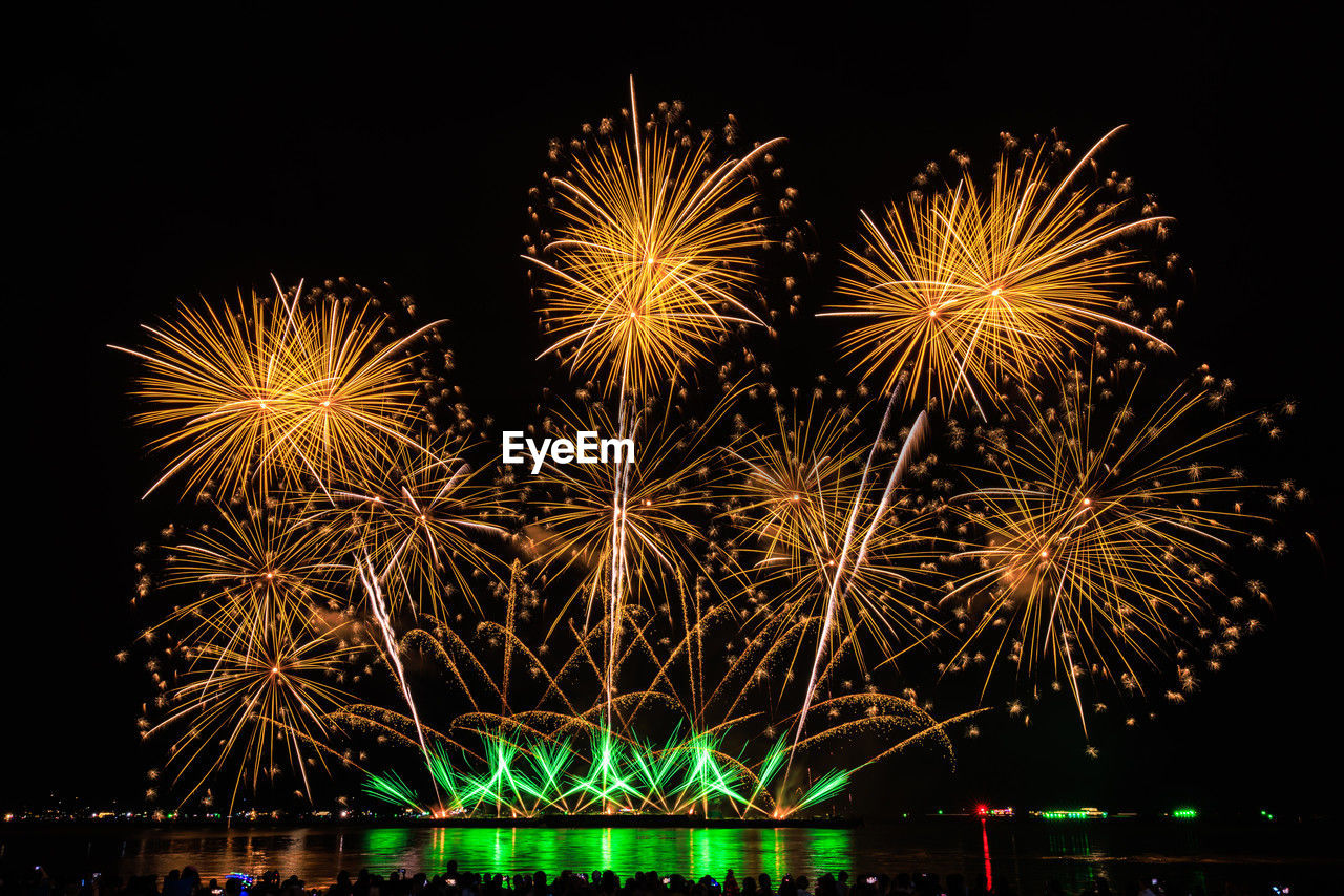 low angle view of firework display against sky at night